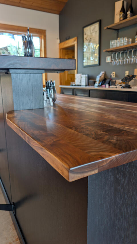 Durant Vineyard tasting room bar featuring solid walnut counters, custom maple cabinets, and blackened quartersawn oak panels Durant Vineyard tasting room bar featuring solid walnut counters, custom maple cabinets, and blackened quartersawn oak panels